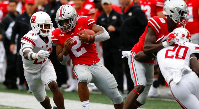 Ohio State running back J.K. Dobbins, center, cuts up field in front of Rutgers defensive back Damon Hayes during the first half of an NCAA college football game Saturday, Sept. 8, 2018, in Columbus, Ohio. Ohio State running back J.K. Dobbins, center, cuts up field in front of Rutgers defensive back Damon Hayes during the first half of an NCAA college football game Saturday, Sept. 8, 2018, in Columbus, Ohio.