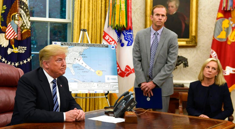 President Donald Trump, left, listens to a reporters question as FEMA Administrator Brock Long, center, and Homeland Security Secretary Kirstjen Nielsen, right, listen during a briefing on Hurricane Florence in the Oval Office of the White House. President Donald Trump, left, listens to a reporters question as FEMA Administrator Brock Long, center, and Homeland Security Secretary Kirstjen Nielsen, right, listen during a briefing on Hurricane Florence in the Oval Office of the White House.