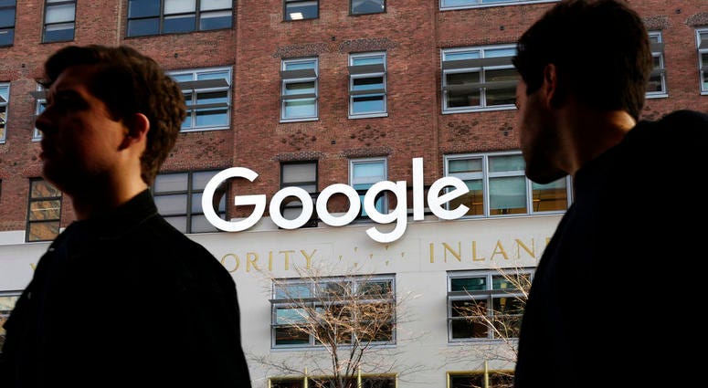 In this Dec. 4, 2017 file photo, people walk by Google offices in New York. In this Dec. 4, 2017 file photo, people walk by Google offices in New York.