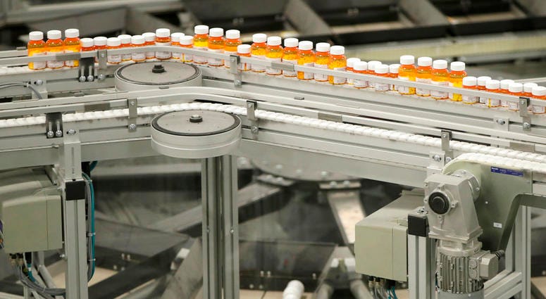 FILE- In this July 10, 2018, file photo bottles of medicine ride on a belt at the Express Scripts mail-in pharmacy warehouse in Florence, N.J. FILE- In this July 10, 2018, file photo bottles of medicine ride on a belt at the Express Scripts mail-in pharmacy warehouse in Florence, N.J.