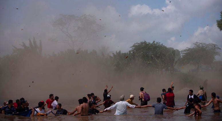 Dust clouds are created by a Mexican Federal Police helicopter flying close to the Suchiate River that connects Mexico and Guatemala, in order to create a downwash force to discourage a new group of Central American migrants bound for the U.S border, in w Dust clouds are created by a Mexican Federal Police helicopter flying close to the Suchiate River that connects Mexico and Guatemala, in order to create a downwash force to discourage a new group of Central American migrants bound for the U.S border, in w