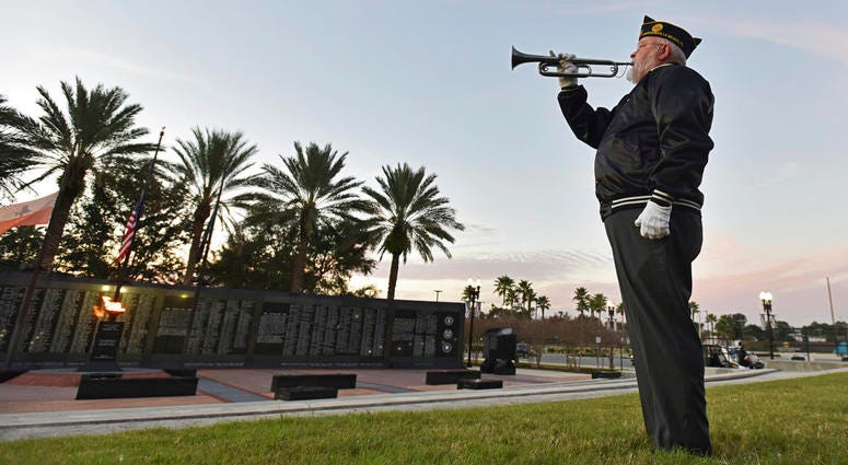 Beaches Honor Guard bugler John Poe plays Taps in honor of former President George H.W. Bush on the day of his funeral Thursday, Dec. 6, 2018 at the Veteran's Memorial Wall at TIAA Bank Field in Jacksonville, Fla. Beaches Honor Guard bugler John Poe plays Taps in honor of former President George H.W. Bush on the day of his funeral Thursday, Dec. 6, 2018 at the Veteran's Memorial Wall at TIAA Bank Field in Jacksonville, Fla.