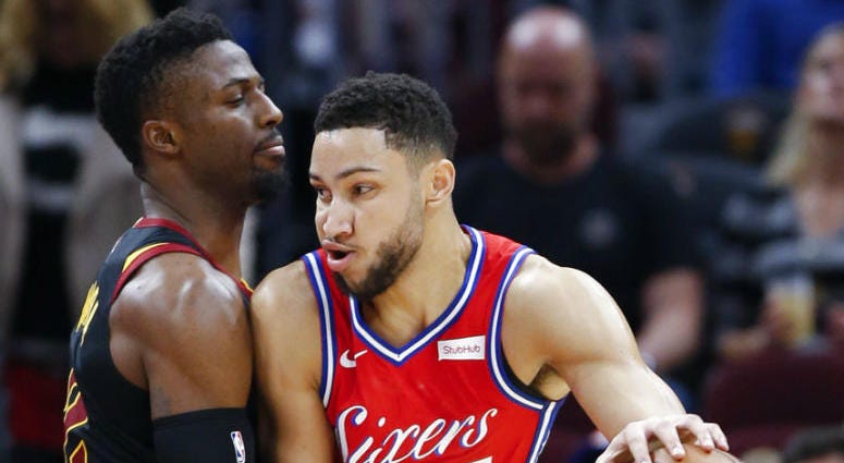 Philadelphia 76ers' Ben Simmons (25), from Australia, tries to drive against Cleveland Cavaliers' David Nwaba, left, during the first half of an NBA basketball game Sunday, Dec. 16, 2018, in Cleveland.