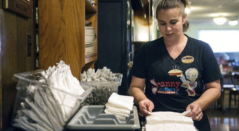 In this Tuesday, Dec. 18, 2018 photo, Shawna Green, waitress at Granny Shaffer's, prepares utensils for customers at the restaurant in Joplin, Mo. In this Tuesday, Dec. 18, 2018 photo, Shawna Green, waitress at Granny Shaffer's, prepares utensils for customers at the restaurant in Joplin, Mo.