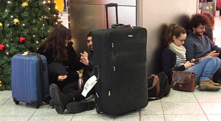 Passengers wait at Gatwick Airport in England, Friday, Dec. 21, 2018. Passengers wait at Gatwick Airport in England, Friday, Dec. 21, 2018.