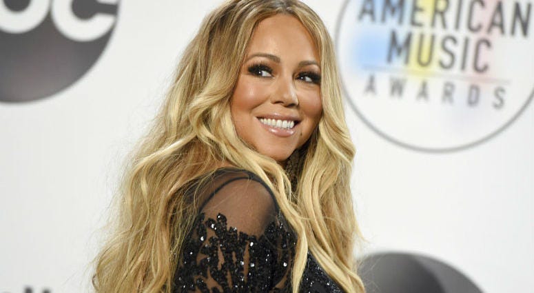 FILE - In this Oct. 9, 2018 file photo, Mariah Carey poses in the press room at the American Music Awards at the Microsoft Theater in Los Angeles. FILE - In this Oct. 9, 2018 file photo, Mariah Carey poses in the press room at the American Music Awards at the Microsoft Theater in Los Angeles.