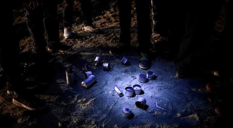 Migrants stand by tear gas canisters they collected that were shot towards the Mexican side by U.S. Border Patrol officers after they attempted to get into the U.S. side to San Diego, Calif., from Tijuana, Mexico, Tuesday, Jan. 1, 2019. Migrants stand by tear gas canisters they collected that were shot towards the Mexican side by U.S. Border Patrol officers after they attempted to get into the U.S. side to San Diego, Calif., from Tijuana, Mexico, Tuesday, Jan. 1, 2019.