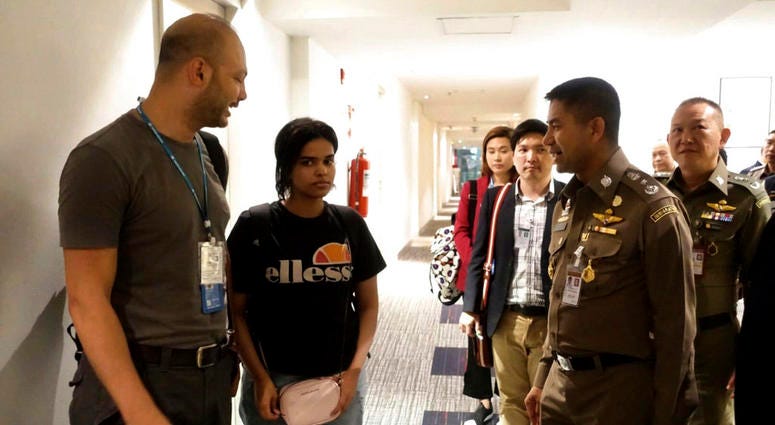 In this photo released by the Immigration Police, Chief of Immigration Police Maj. Gen. Surachate Hakparn, right talks to Saudi woman Rahaf Mohammed Alqunun,second left, before leaving the Suvarnabhumi Airport in Bangkok Monday, Jan. 7, 2019. In this photo released by the Immigration Police, Chief of Immigration Police Maj. Gen. Surachate Hakparn, right talks to Saudi woman Rahaf Mohammed Alqunun,second left, before leaving the Suvarnabhumi Airport in Bangkok Monday, Jan. 7, 2019.