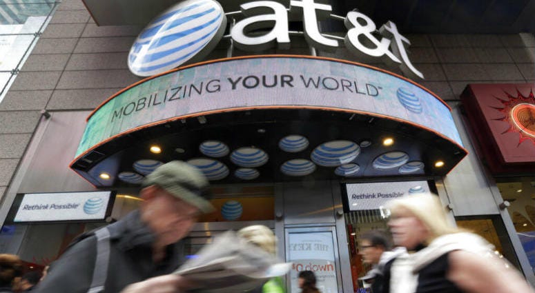 In this Oct. 21, 2014 file photo, people pass an AT&T store in New York's Times Square. AT&T says it will stop selling customer location data to data brokers, as the telecom industry faces backlash that the data has been used improperly. In this Oct. 21, 2014 file photo, people pass an AT&T store in New York's Times Square. AT&T says it will stop selling customer location data to data brokers, as the telecom industry faces backlash that the data has been used improperly.