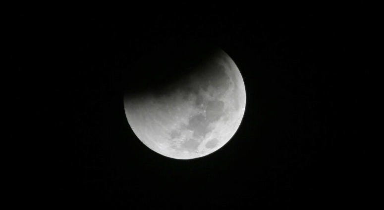 FILE - In this Saturday Aug. 28, 2018 file photo, Earth starts to cast its shadow on the moon during a complete lunar eclipse seen from Jakarta, Indonesia. FILE - In this Saturday Aug. 28, 2018 file photo, Earth starts to cast its shadow on the moon during a complete lunar eclipse seen from Jakarta, Indonesia.