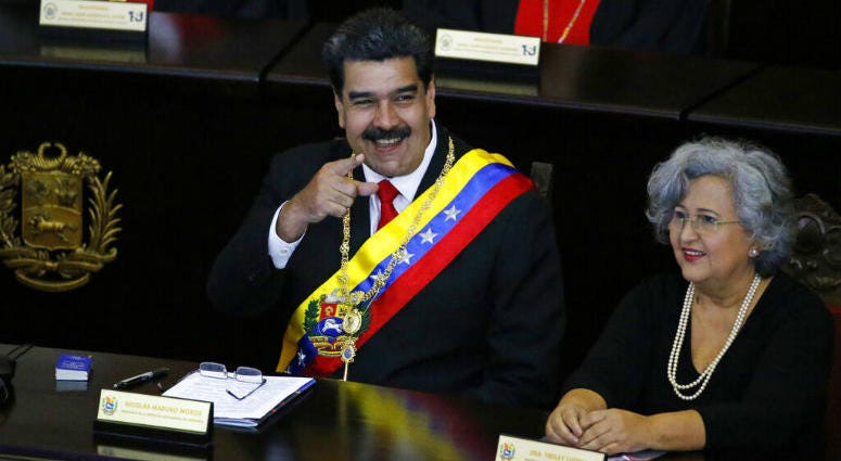 Venezuelan President Nicolas Maduro points to someone in the crowd as he sits inside the Supreme Court for an annual ceremony that marks the start of the judicial year in Caracas, Venezuela, Thursday, Jan. 24, 2019. Venezuelan President Nicolas Maduro points to someone in the crowd as he sits inside the Supreme Court for an annual ceremony that marks the start of the judicial year in Caracas, Venezuela, Thursday, Jan. 24, 2019.