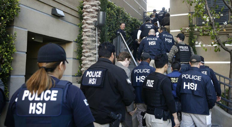 FILE - In this March 3, 2015 file photo, federal agents enter an upscale apartment complex where authorities say a birth tourism business charged pregnant women $50,000 for lodging, food and transportation, in Irvine, Calif. FILE - In this March 3, 2015 file photo, federal agents enter an upscale apartment complex where authorities say a birth tourism business charged pregnant women $50,000 for lodging, food and transportation, in Irvine, Calif.