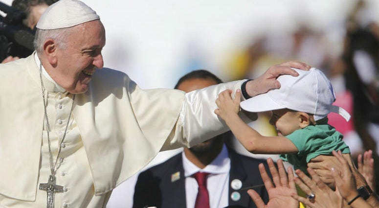 Pope Francis blesses a boy during a Mass at the Sheikh Zayed Sports City in Abu Dhabi, United Arab Emirates, Tuesday, Feb. 5, 2019. Pope Francis blesses a boy during a Mass at the Sheikh Zayed Sports City in Abu Dhabi, United Arab Emirates, Tuesday, Feb. 5, 2019.