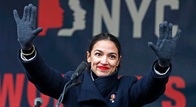 In this Jan. 19, 2019, file photo, U.S. Rep. Alexandria Ocasio-Cortez, (D-New York) waves to the crowd after speaking at Women's Unity Rally in Lower Manhattan in New York. U.S. Rep. Alexandria Ocasio-Cortez