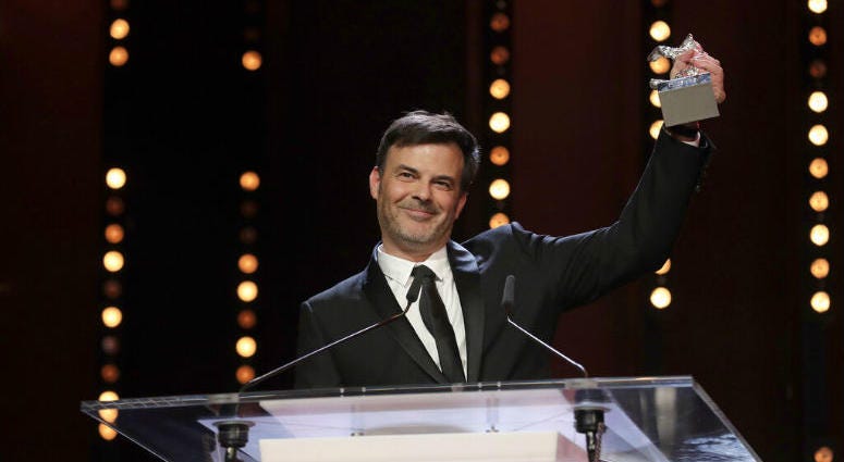Director Francois Ozon holds aloft the Silver Bear grand jury prize for the film 'By the Grace of God' onstage at the award ceremony of the 2019 Berlinale Film Festival in Berlin, Germany, Saturday, Feb. 16, 2019. Director Francois Ozon holds aloft the Silver Bear grand jury prize for the film 'By the Grace of God' onstage at the award ceremony of the 2019 Berlinale Film Festival in Berlin, Germany, Saturday, Feb. 16, 2019.