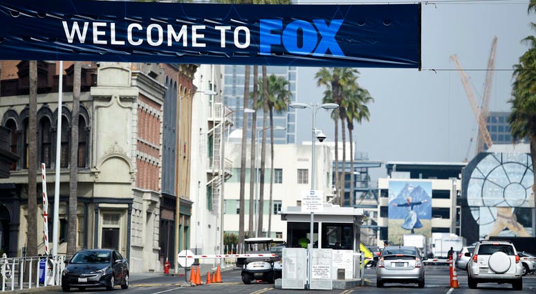 Cars enter and leave Fox Studios, Tuesday, March 19, 2019, in Los Angeles. Cars enter and leave Fox Studios.