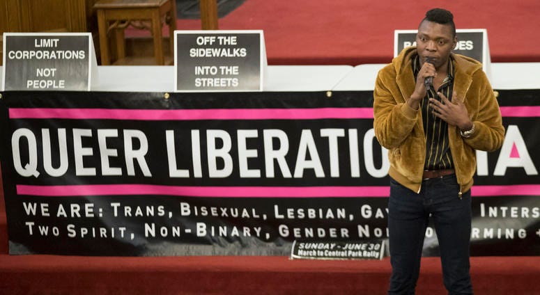 In this March 27, 2019, photo, Nigerian activist Michael Ighodaro speaks during a meeting of the Reclaim Pride Coalition at the Church of the Village in New York. In this March 27, 2019, photo, Nigerian activist Michael Ighodaro speaks during a meeting of the Reclaim Pride Coalition at the Church of the Village in New York.
