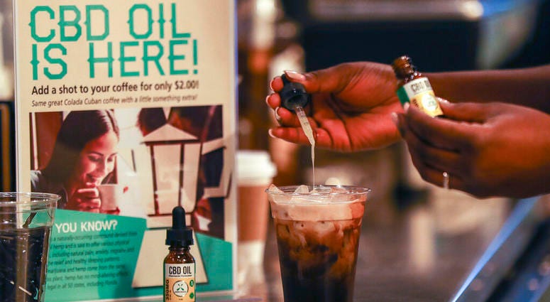 In this Friday, Jan. 4, 2018 file photo, a worker adds CBD oil to a drink at a coffee shot in Fort Lauderdale, Fla. CBD oil