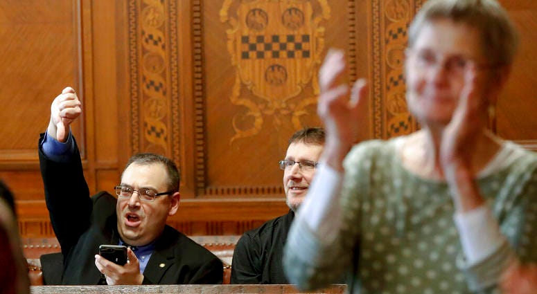 Val Finnell, left, gives a thumbs down, as others applaud after the Pittsburgh City Council voted 6-3 to pass gun-control legislation, Tuesday, April 2, 2019, in Pittsburgh. Pittsburgh City Council