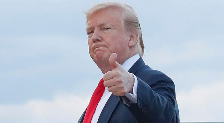 In this April 21, 2019 photo, President Donald Trump gives a 'thumbs-up' as he walks across the tarmac during his arrival on Air Force One at Andrews Air Force Base, Md. President Donald Trump