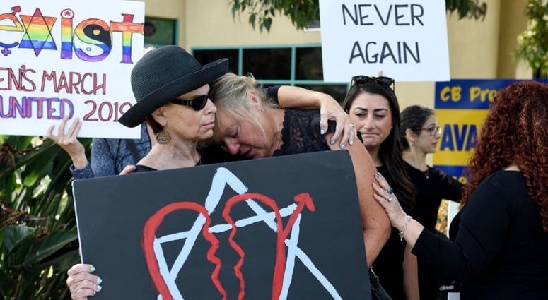 Leslie Gollub, left, and Gretchen Gordon hug at a vigil held to support the victims of the Chabad of Poway synagogue shooting, Sunday, April 28, 2019, in Poway, Calif. Poway, California synagogue shooting