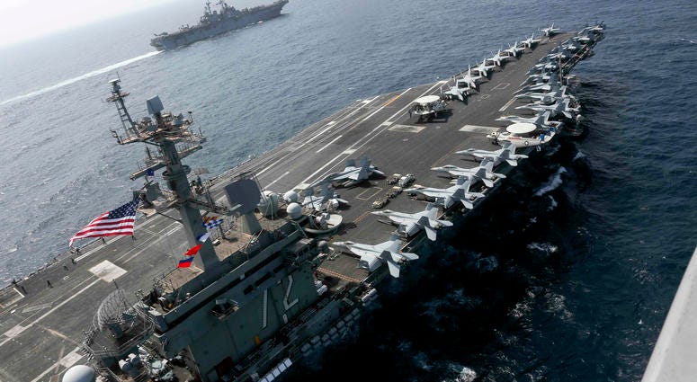 In this Friday, May 17, 2019, photo released by the U.S. Navy, the USS Abraham Lincoln sails in the Arabian Sea near the amphibious assault ship USS Kearsarge. USS Abraham Lincoln sails in the Arabian Sea.