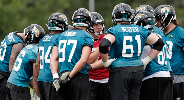 Jacksonville Jaguars quarterback Nick Foles, center, calls a play in the huddle during an NFL football practice, Friday, May 31, 2019, in Jacksonville, Fla. Jacksonville Jaguars quarterback Nick Foles