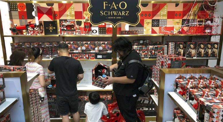 In this Saturday, June 1, 2019, photo, Chinese shop for toys at the newly opened FAO Schwarz toy store at the capital city's popular shopping mall in Beijing. China issued a report Sunday blaming the United States for a trade dispute and says it won't back down on "major issues of principle."