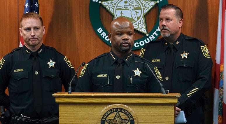 Broward Sheriff Gregory Tony, center, announces that two additional deputies have been fired as a result of the agency's internal affairs investigation into the mass shooting at Marjory Stoneman Douglas High School in Parkland, June 26, 2019. Broward County police