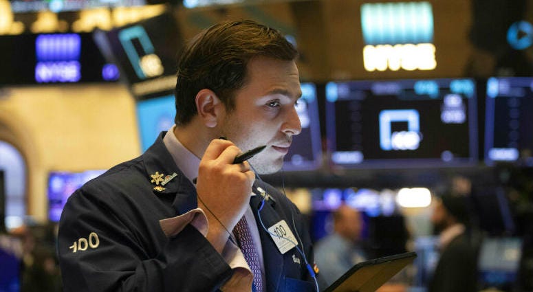 FILE - In this July 5, 2019, file photo trader Benjamin Tuchman works at the New York Stock Exchange in New York. The U.S. stock market opens at 9:30 a.m. EDT on Thursday, July 11. Dow Jones industrials cross 27,000 points for first time