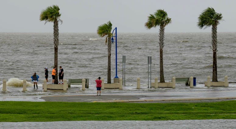 People check out the waves on Lakeshore Drive in New Orleans, La., Friday, July 12, 2019, as water moves in from Lake Pontchartrain from the storm surge from Tropical Storm Barry in the Gulf of Mexico. People check out the waves on Lakeshore Drive in New Orleans, La., Friday, July 12, 2019, as water moves in from Lake Pontchartrain from the storm surge from Tropical Storm Barry in the Gulf of Mexico.