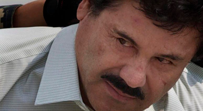 In this Feb. 22, 2014, file photo, Joaquin "El Chapo" Guzman is escorted to a helicopter in handcuffs by Mexican navy marines at a navy hanger in Mexico City. In this Feb. 22, 2014, file photo, Joaquin "El Chapo" Guzman is escorted to a helicopter in handcuffs by Mexican navy marines at a navy hanger in Mexico City.