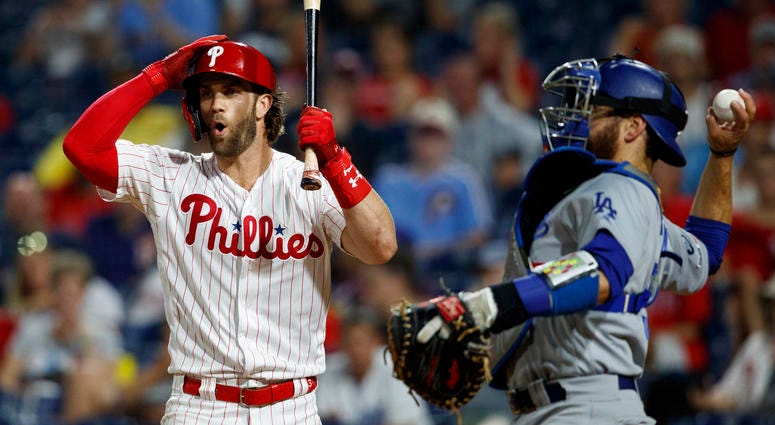 Philadelphia Phillies' Bryce Harper, left, reacts after striking out against Los Angeles Dodgers relief pitcher Julio Urias during the fourth inning of a baseball game Wednesday, July 17, 2019, in Philadelphia. Philadelphia Phillies' Bryce Harper, left, reacts after striking out against Los Angeles Dodgers relief pitcher Julio Urias during the fourth inning of a baseball game Wednesday, July 17, 2019, in Philadelphia.