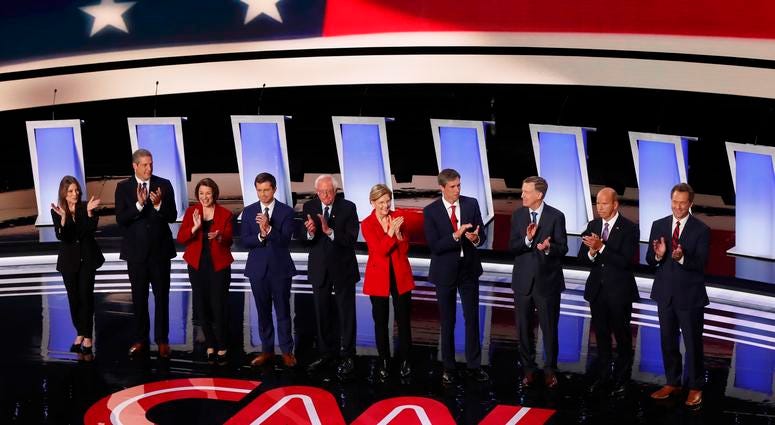 From left: Marianne Williamson, Tim Ryan, Amy Klobuchar, Pete Buttigieg, Bernie Sanders, Elizabeth Warren, Beto O'Rourke, John Hickenlooper, John Delaney and Steve Bullock take the stage for a Democratic primary debate in Detroit. From left: Marianne Williamson, Tim Ryan, Amy Klobuchar, Pete Buttigieg, Bernie Sanders, Elizabeth Warren, Beto O'Rourke, John Hickenlooper, John Delaney and Steve Bullock take the stage for a Democratic primary debate in Detroit.