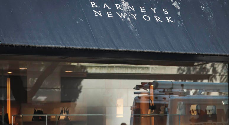 In this July 16, 2019, file photo a pedestrian reflect in a store window at Barneys department store in New York. In this July 16, 2019, file photo a pedestrian reflect in a store window at Barneys department store in New York.