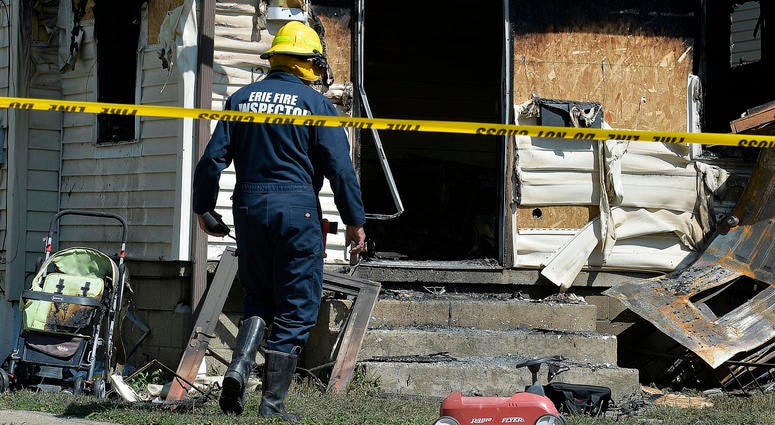 Erie Bureau of Fire Inspector Mark Polanski helps investigate a fatal fire at 1248 West 11th St. in Erie, Pa., Aug. 11, 2019. Erie Bureau of Fire Inspector