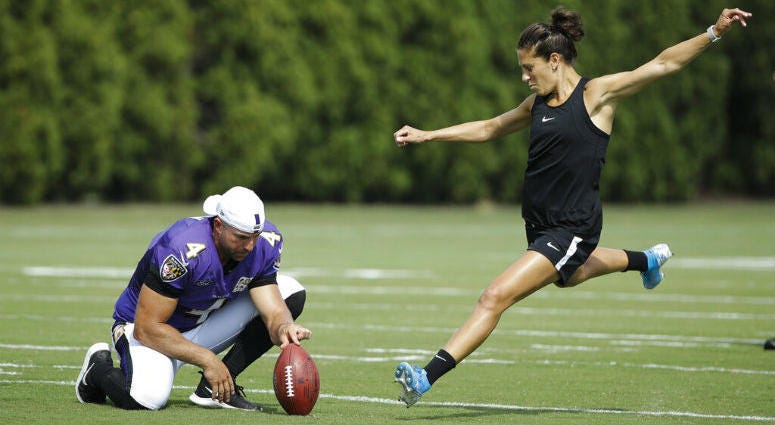 Baltimore Ravens' Sam Koch holds the ball for United States soccer player Carli Lloyd as she attempts to kick a field goal after the Philadelphia Eagles and the Baltimore Ravens held a joint NFL football practice in Philadelphia, Tuesday, Aug. 20, 2019. Baltimore Ravens' Sam Koch holds the ball for United States soccer player Carli Lloyd as she attempts to kick a field goal after the Philadelphia Eagles and the Baltimore Ravens held a joint NFL football practice in Philadelphia, Tuesday, Aug. 20, 2019.