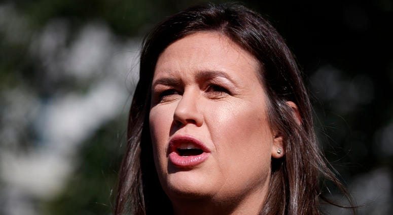 In this June 11, 2019 file photo, White House press secretary Sarah Sanders talks with reporters outside the White House in Washington. Sarah Sanders