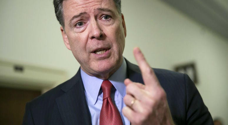 FILE - In this Dec. 17, 2018, file photo, former FBI Director James Comey speaks to reporters on Capitol Hill Washington. he Justice Department’s inspector general says former FBI Director James Comey violated FBI policies in his handling of memos.