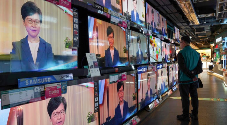 A man watches the television message that Hong Kong Chief Executive Carrie Lam makes an announcement on the extradition bill, at a home electronics retailer in Hong Kong, on Wednesday, Sept. 4, 2019. A man watches the television message that Hong Kong Chief Executive Carrie Lam makes an announcement on the extradition bill, at a home electronics retailer in Hong Kong, on Wednesday, Sept. 4, 2019.