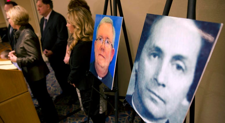 A photo of Rev. Robert Brennan, right, is displayed during a news conference in Philadelphia, Nov. 13, 2013, where attorneys for the family of Sean McIlmail, an alleged priest-abuse victim, announced a wrongful death lawsuit against church officials. Robert Brennan lawsuit