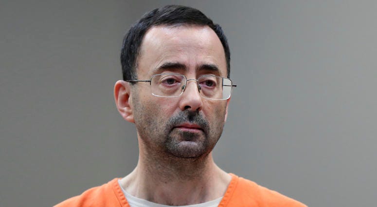 In this Nov. 22, 2017, file photo, Larry Nassar, 54, appears in court for a plea hearing in Lansing, Mich. The Education Department is fining Michigan State University $4.5 million for failing to respond to sexual assault complaints against Larry Nassar. Larry Nassar