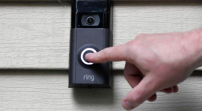 In this Tuesday, July 16, 2019, file photo, Ernie Field pushes the doorbell on his Ring doorbell camera at his home in Wolcott, Conn. Ring doorbell camera