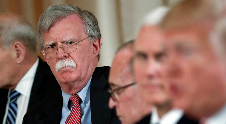 In this April 18, 2018 file photo, National security adviser John Bolton, left, listens to President Donald Trump, far right, speak during a working lunch with Japanese Prime Minister Shinzo Abe at Trump' s private Mar-a-Lago club in Palm Beach, Fla. John Bolton