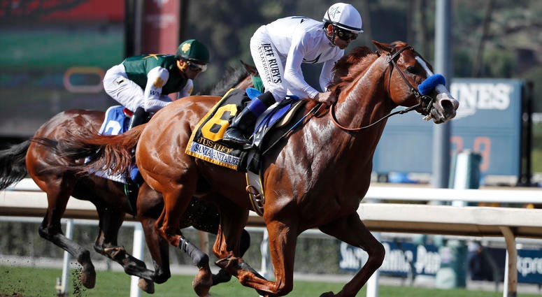 In this April 7, 2018, file photo, Justify, ridden by Mike Smith, gallops past Bolt d'Oro, left, with jockey Javier Castellano, during the Santa Anita Derby horse race at Santa Anita in Arcadia, Calif. Justify race horse