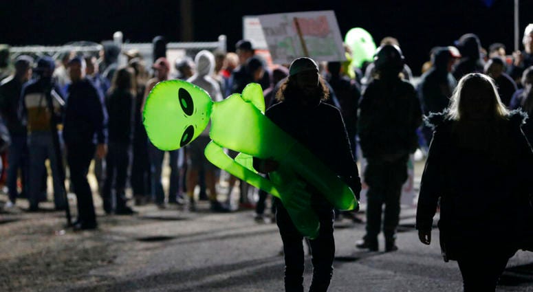 A mans holds an inflatable alien at an entrance to the Nevada Test and Training Range near Area 51 Friday, Sept. 20, 2019, near Rachel, Nev. A mans holds an inflatable alien at an entrance to the Nevada Test and Training Range near Area 51 Friday, Sept. 20, 2019, near Rachel, Nev.