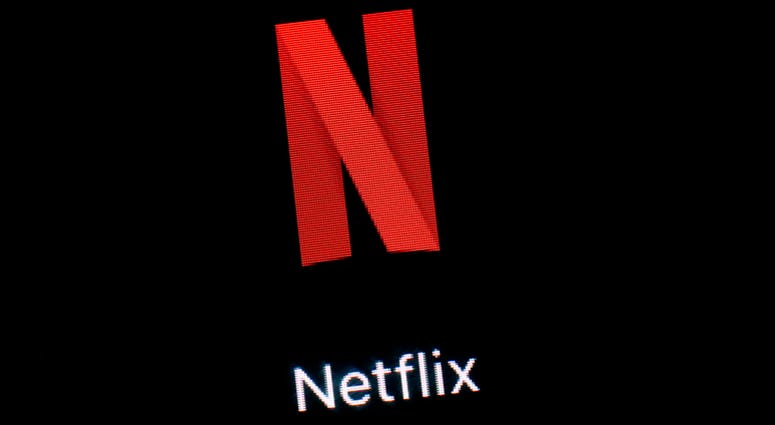 This March 19, 2018, file photo shows the Netflix app on an iPad in Baltimore. Shares of Netflix could open in negative territory for the year, for the first time since 2016, as major media players step into the stream to fight for subscribers. File photo shows the Netflix app on an iPad in Baltimore.