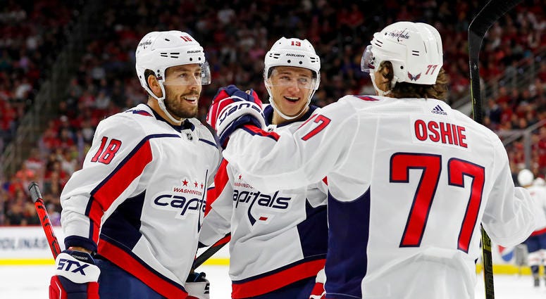 Washington Capitals' T.J. Oshie (77) celebrates his goal with teammate Chandler Stephenson (18) and Jakub Vrana (13) of Czech Republic during the first period of an NHL preseason hockey game against the Carolina Hurricanes, in Raleigh, N.C. Washington Capitals' T.J. Oshie (77) celebrates his goal with teammate Chandler Stephenson (18) and Jakub Vrana (13) of Czech Republic during the first period of an NHL preseason hockey game against the Carolina Hurricanes, in Raleigh, N.C.