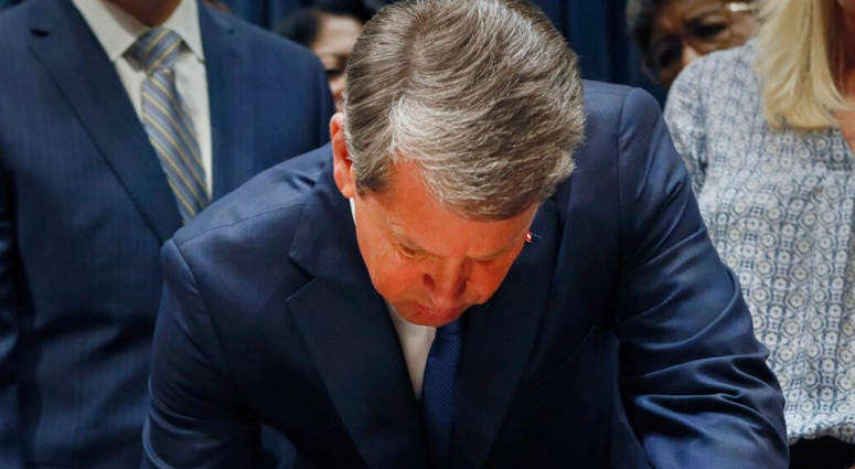 Georgia's Republican Gov. Brian Kemp signing legislation, in Atlanta, banning abortions once a fetal heartbeat can be detected. Georgia's Republican Gov. Brian Kemp signing legislation, in Atlanta, banning abortions once a fetal heartbeat can be detected.