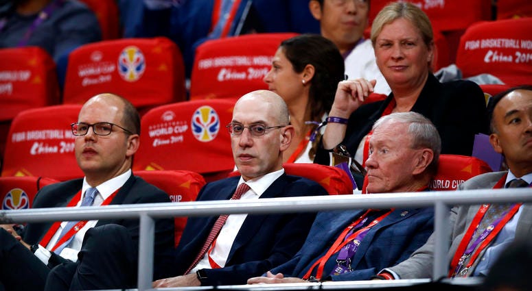 In this Sept. 13, 2019, file photo, NBA Commissioner Adam Silver, second from left, attends the semifinal match between Argentina and France in the FIBA Basketball World Cup at the Cadillac Arena in Beijing. NBA Commissioner Adam Silver
